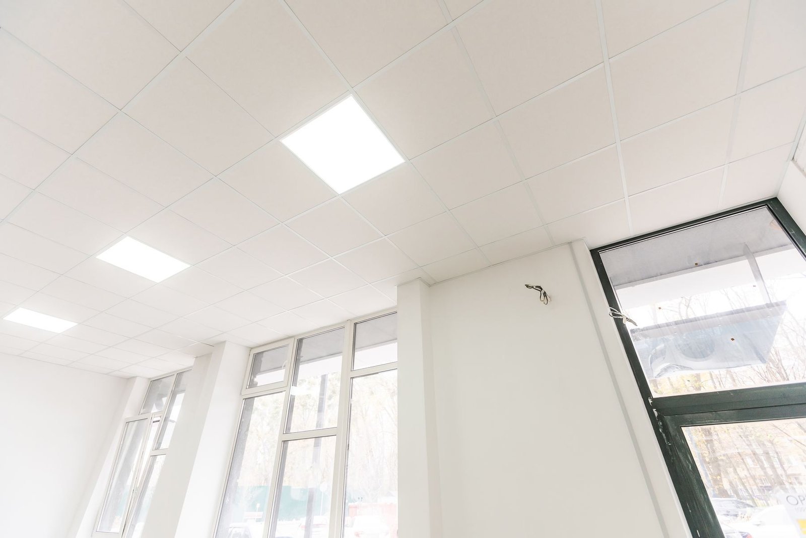 Suspended ceiling grid with exposed services above