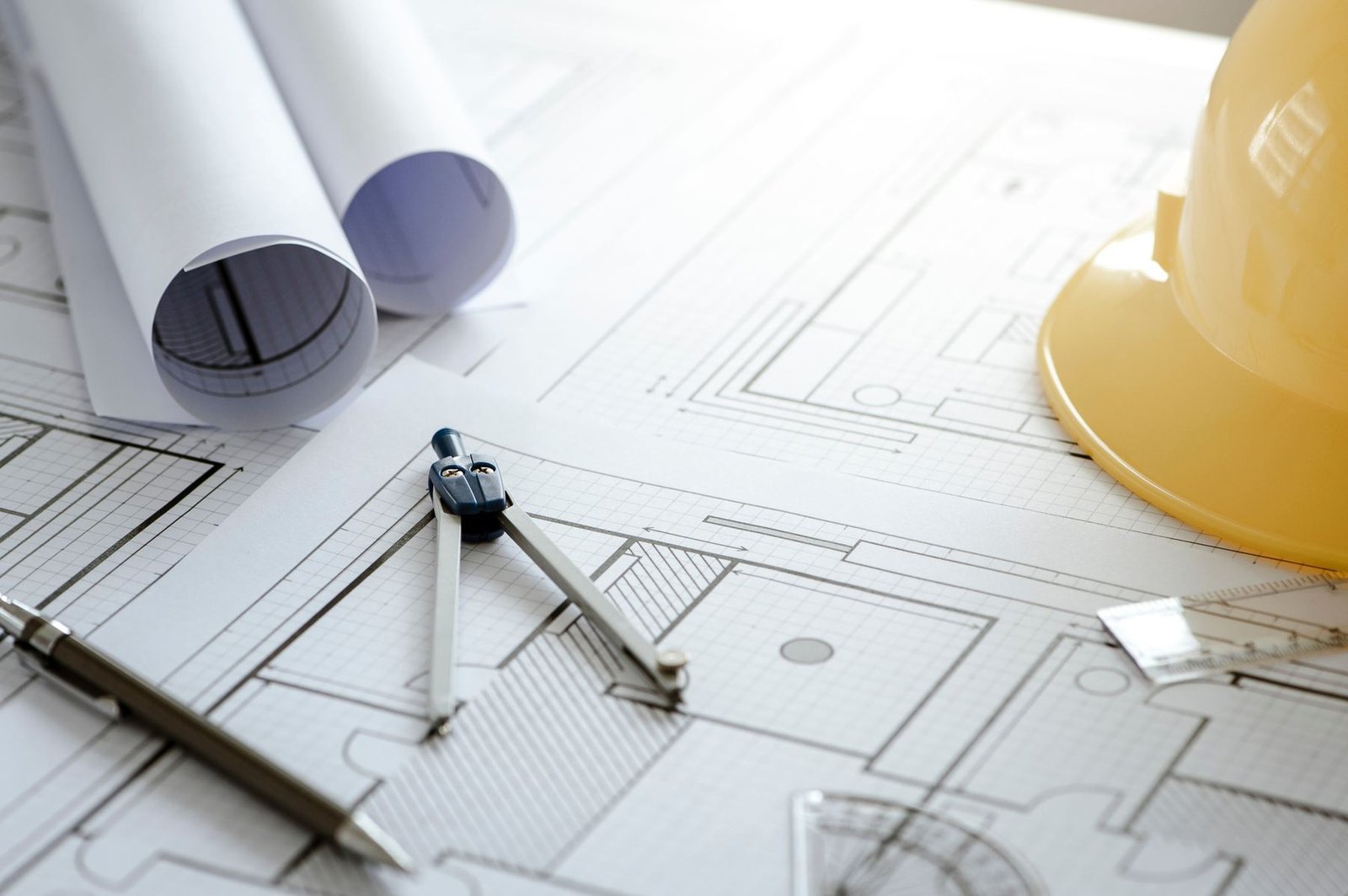 Two contractors reviewing construction drawings on a jobsite